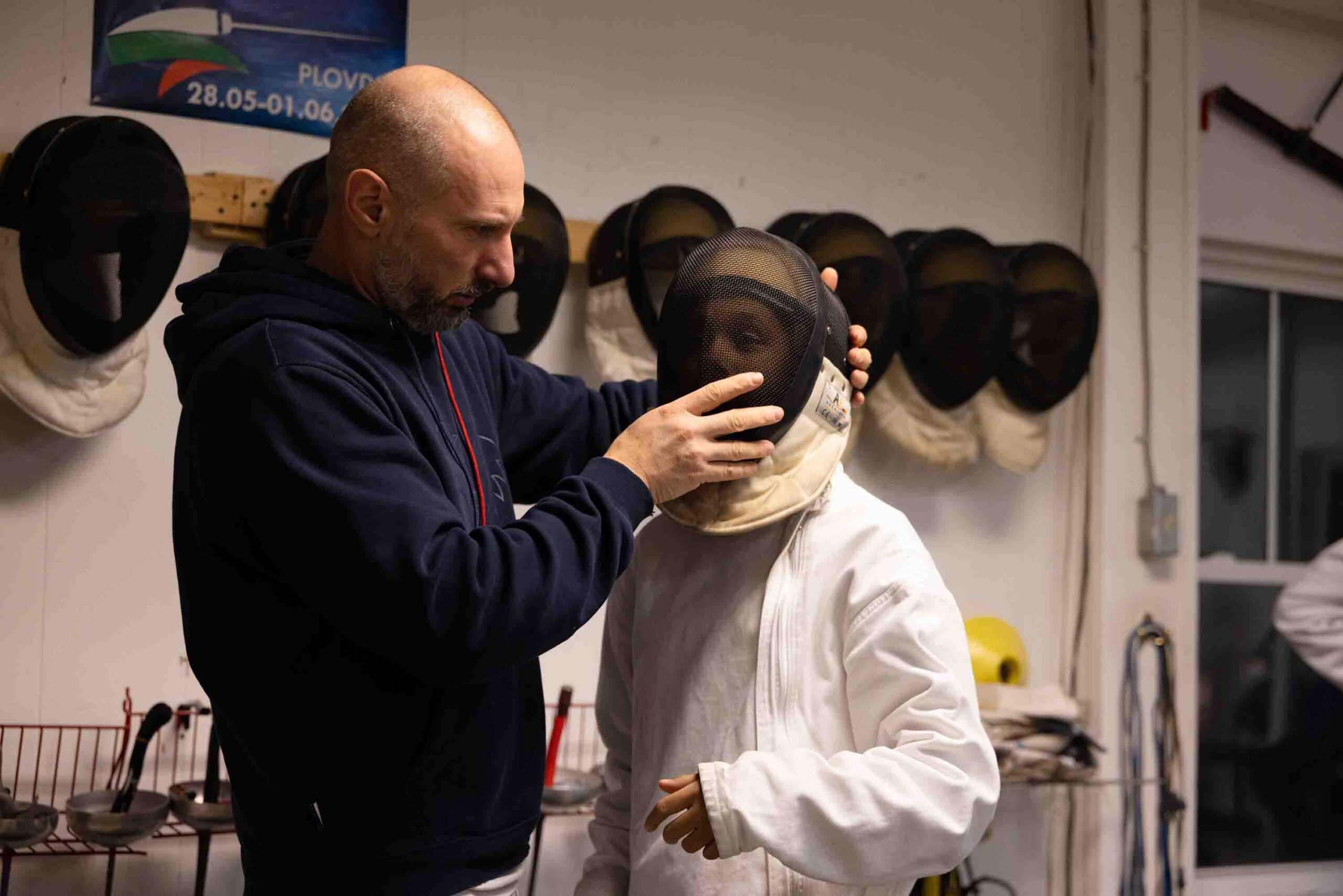 Kalpaktchiev helps a student wear their mask for practice.