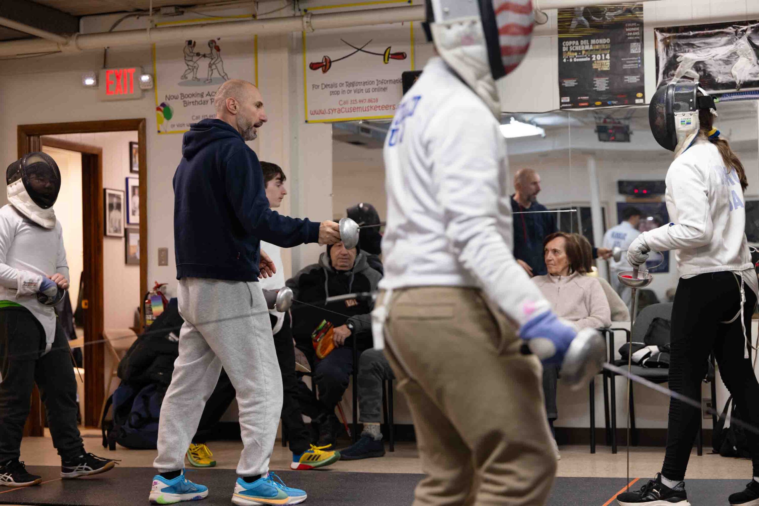 Kalpaktchiev instructs students on technique during practice in the Syracuse Musketeers Fencing Club.