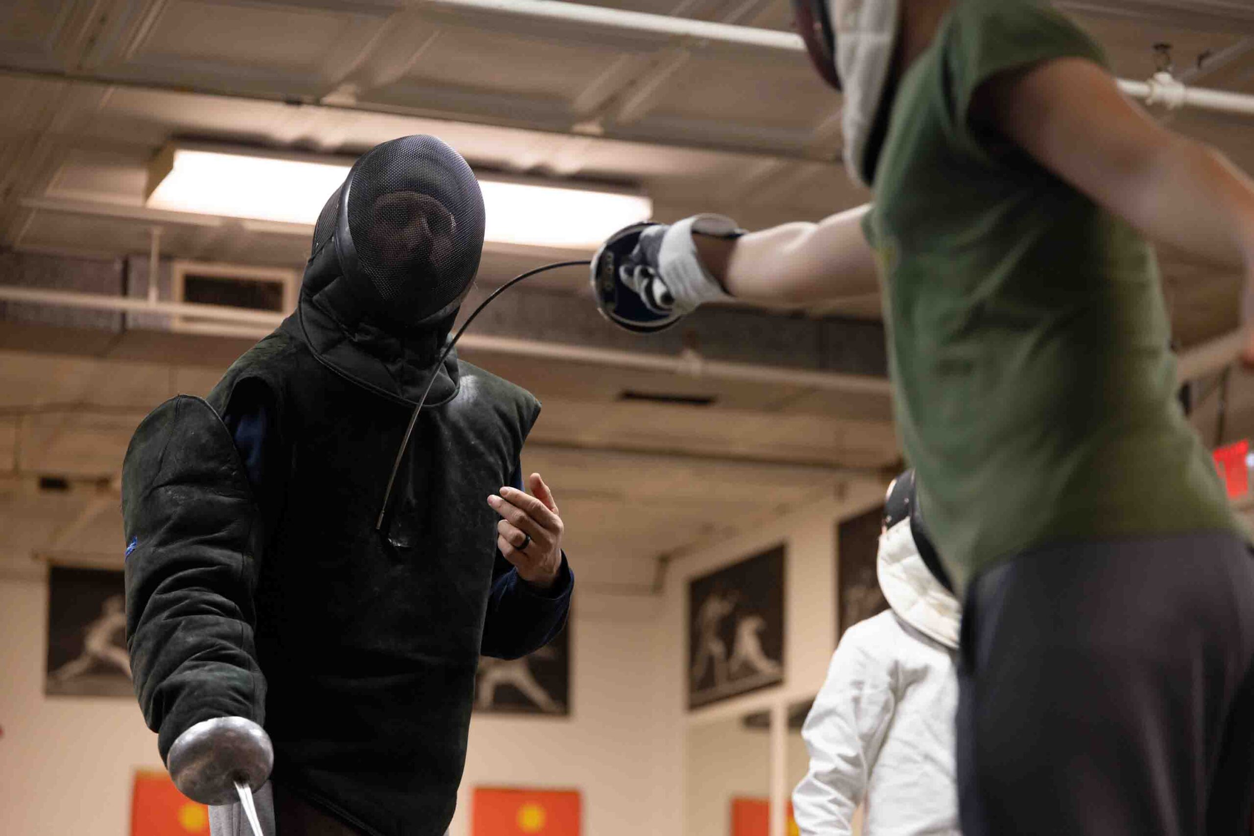 Kalpaktchiev instructs students on technique during practice in the Syracuse Musketeers Fencing Club.