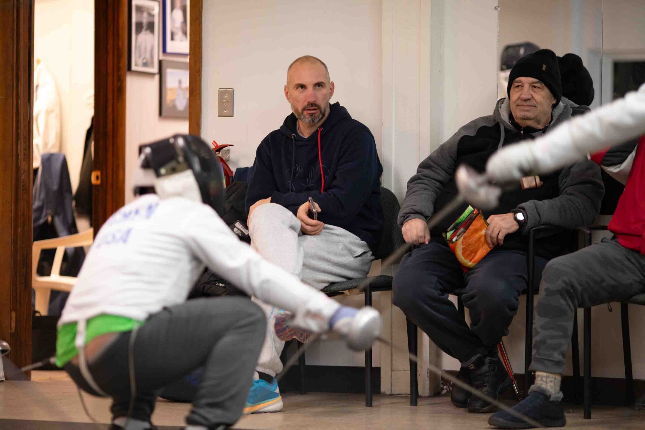 Kalpaktchiev observes students doing participating in practice matches in the Syracuse Musketeers Fencing Club.