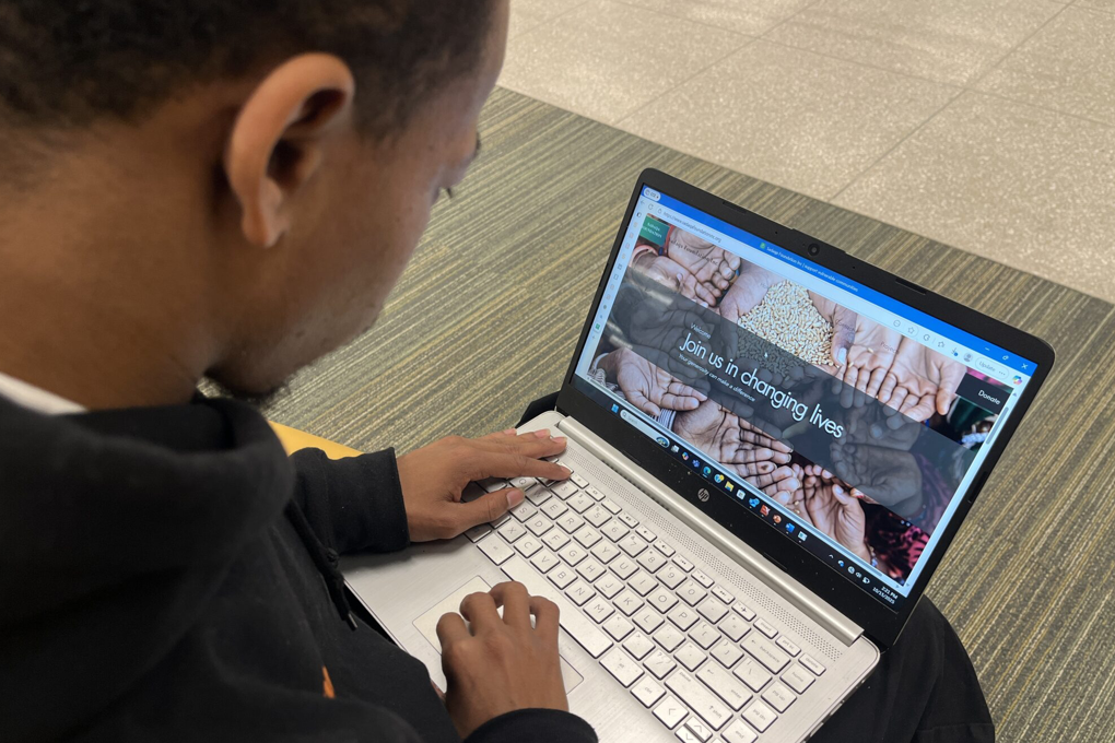 Abdul Rahman Abdi examines his nonprofit organization’s website for Sadaqa Foundation Inc.