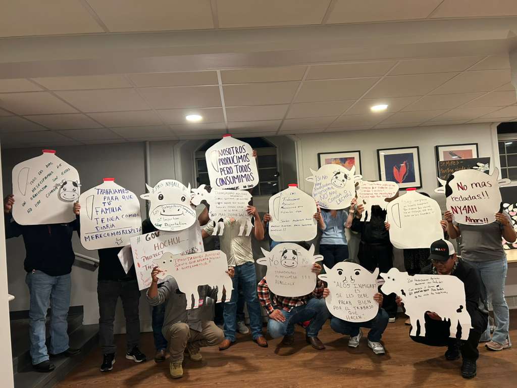 Group members of Alianza Agrícola drew cows and milk jugs with messages that translate to: “We work so your family can have food every day,” “We produce, but everyone consumes,” “Immigrants deserve to be paid well for all the work they do,” and “No more raids. NY4All now!”