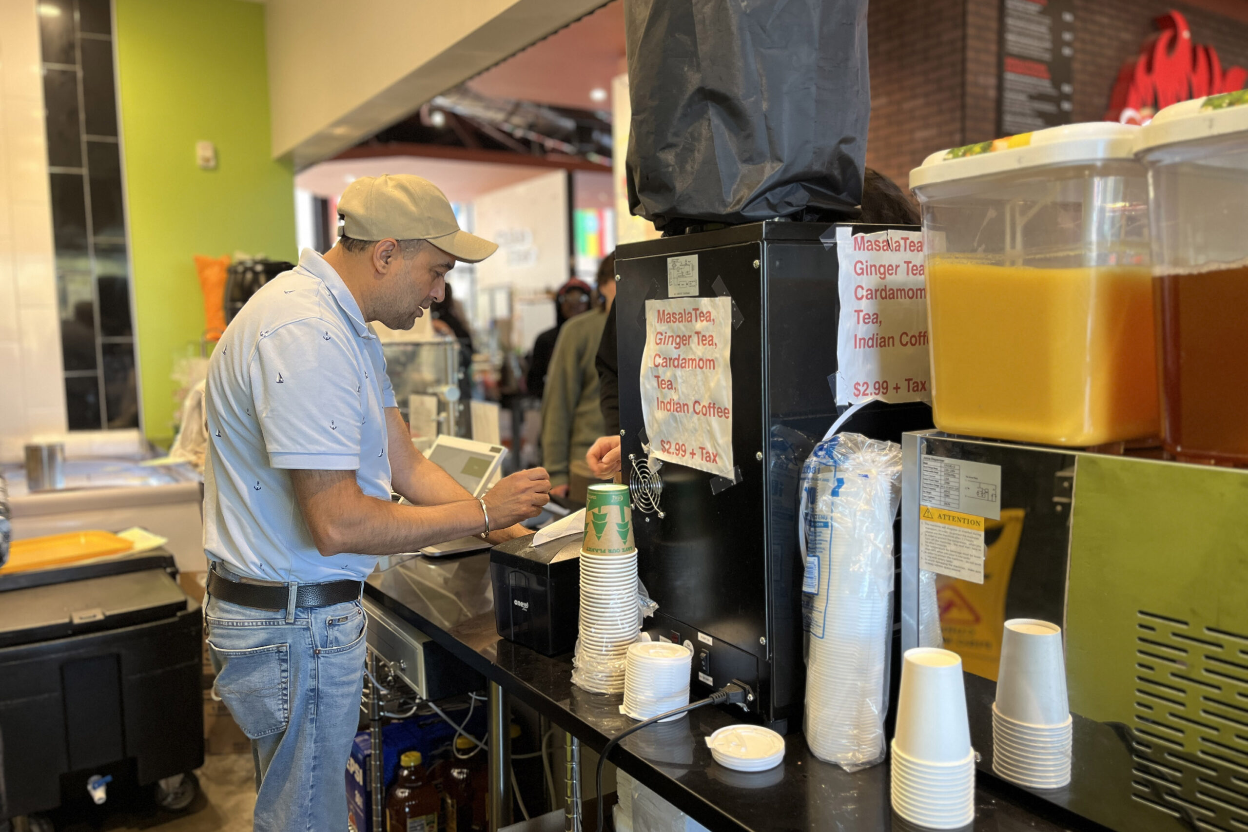 Gary Singh, owner of Masala Heaven, takes an order from a customer at the Salt City Market in Syracuse, New York.