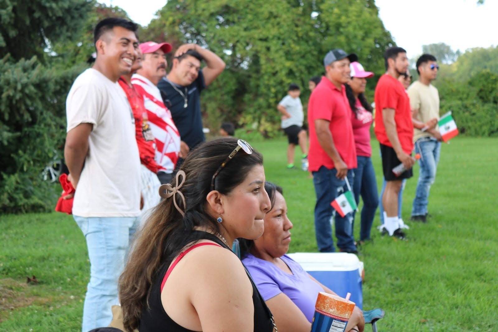 Families look on at a soccer game for farmworkers in western New York.