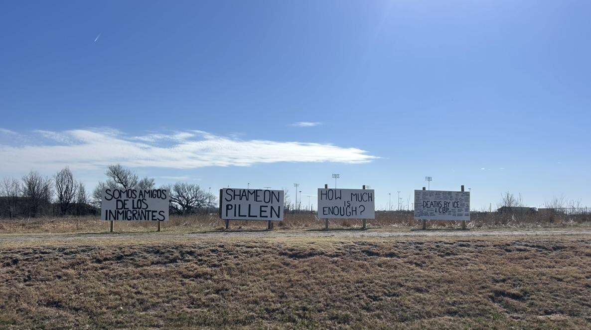 Four wooden signs sit alongside Highway 83 on the plot of land next to the so-called “Cornhusker Clink."
