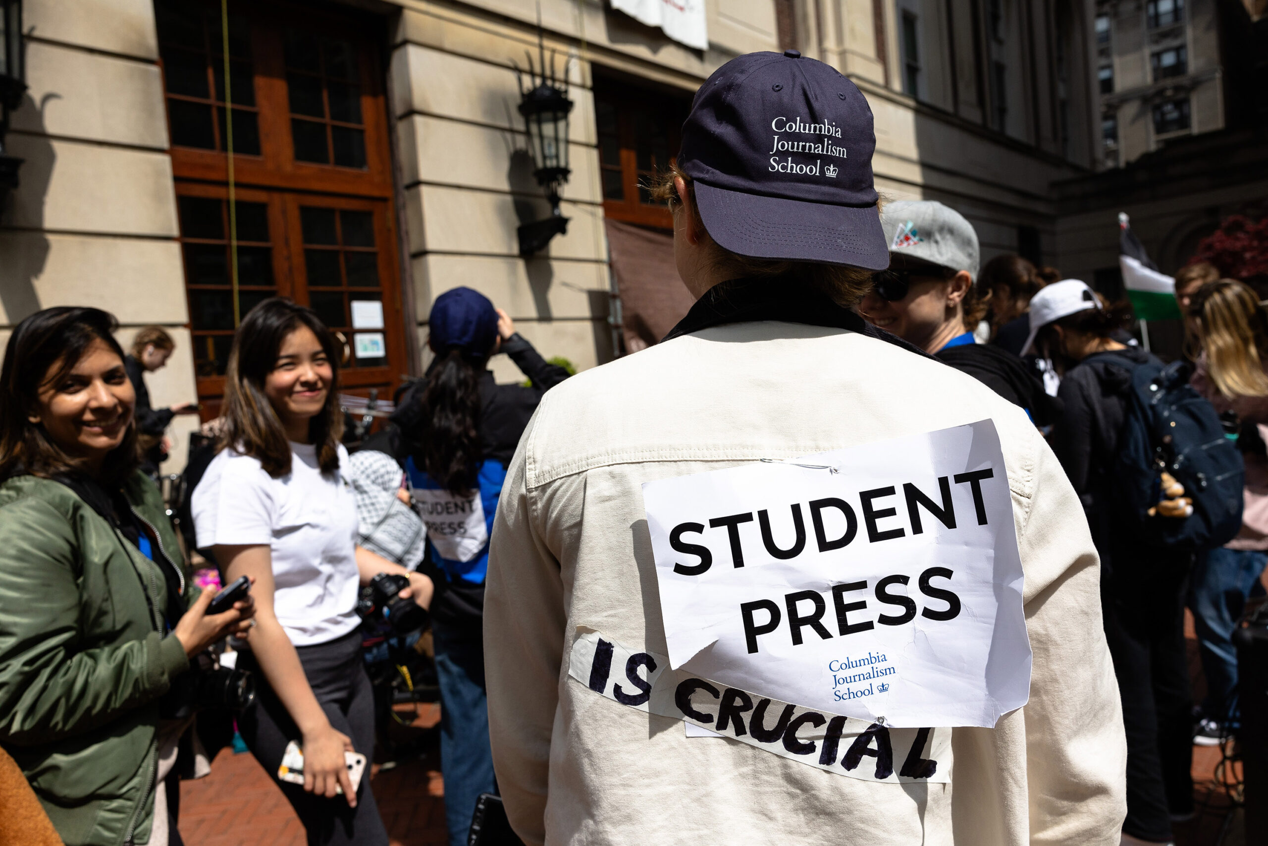 A Columbia Journalism student journalist shows off their sign as they cover the events at Hamilton Hall at Columbia University on April 30, 2024 in New York City.