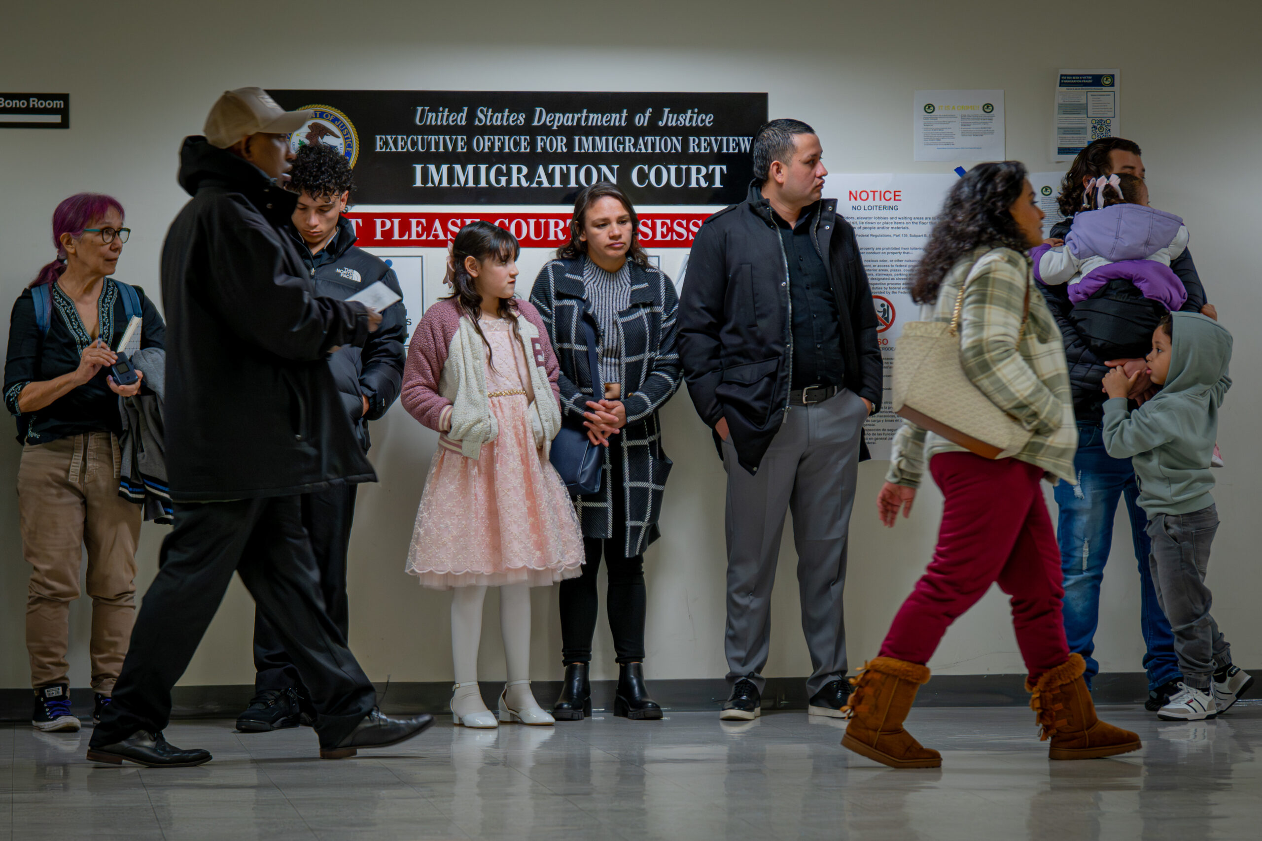 A young boy grows restless while waiting in line during a relative's immigration check-in at the Jacob K. Javits Federal Building in New York on March 10, 2026. Long waits are common during morning hours at the building. Some families bring their children to immigration appointments out of concern it may be the last time they will be together.