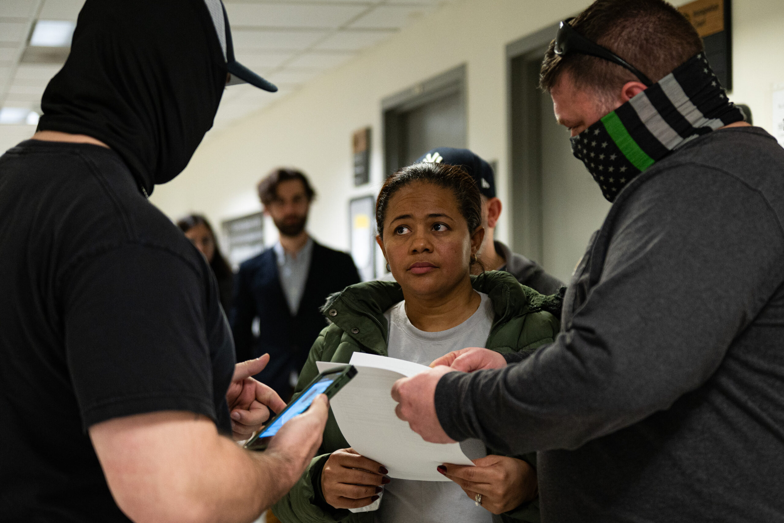 A woman is stopped and questioned by ICE agents on the 12th floor of the Jacob K. Javits Federal Building in New York on March 10, 2026. Agents told the woman and journalists present that she was not a target. After obtaining her name, however, agents waited outside her courtroom for several hours before following her to the elevator bay and detaining her.