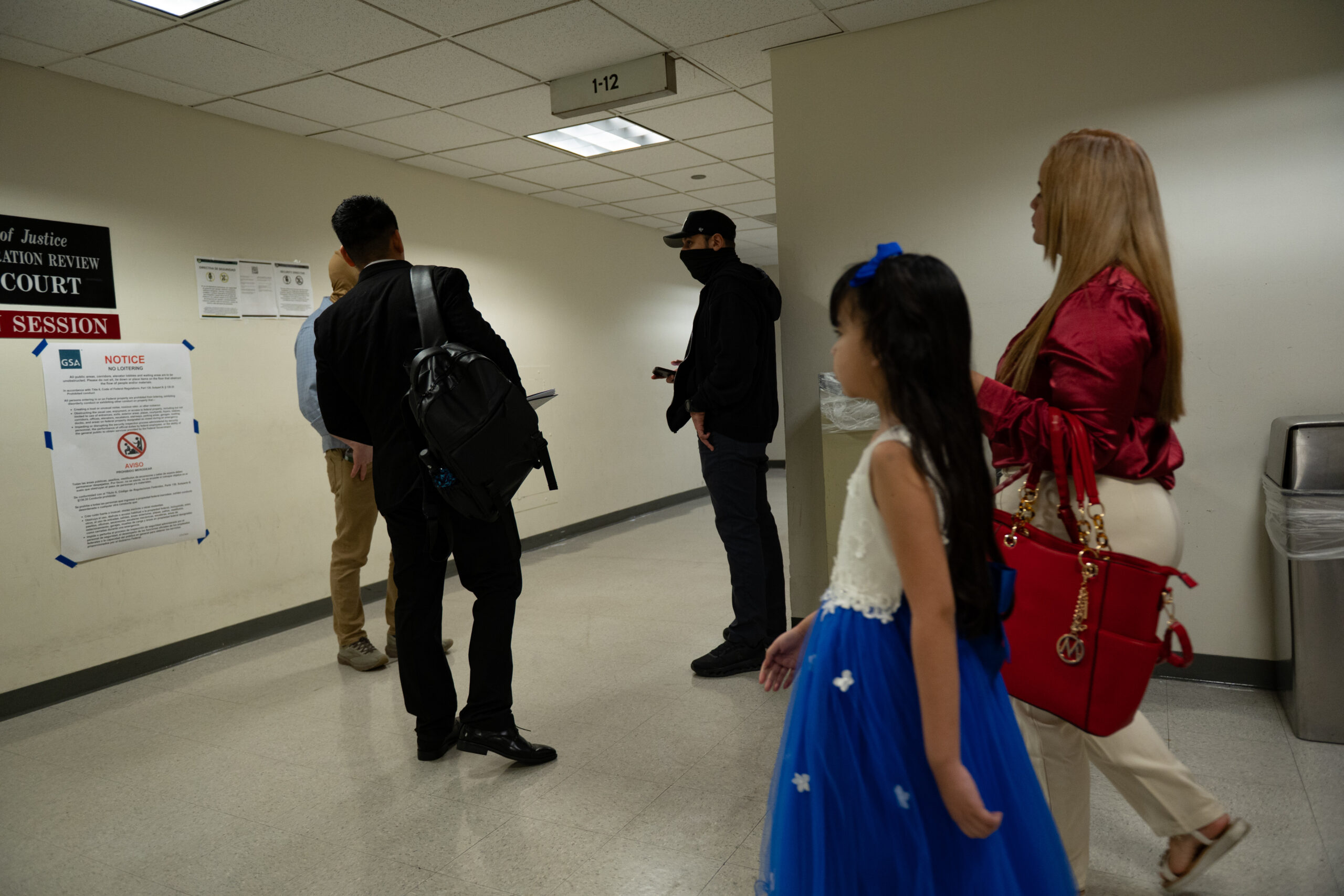 A father and his family search for their courtroom ahead of an immigration check-in appointment on the 12th floor of the Jacob K. Javits Federal Building in New York on March 10, 2026.