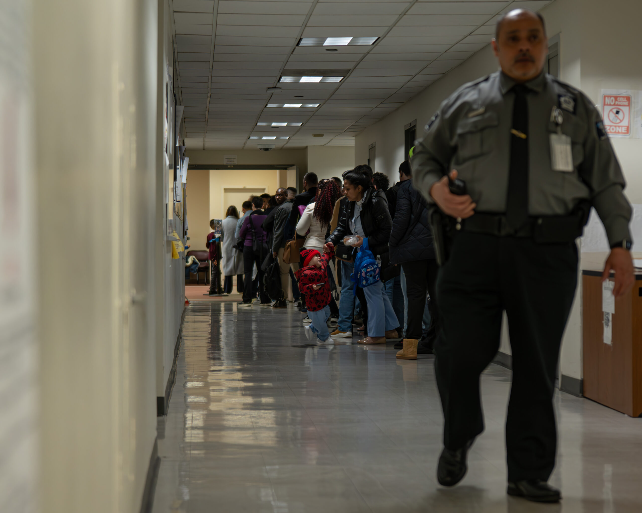 Families line the hallways of 26 Federal Plaza in New York on March 9, 2026. Many dress up for immigration check-in appointments.