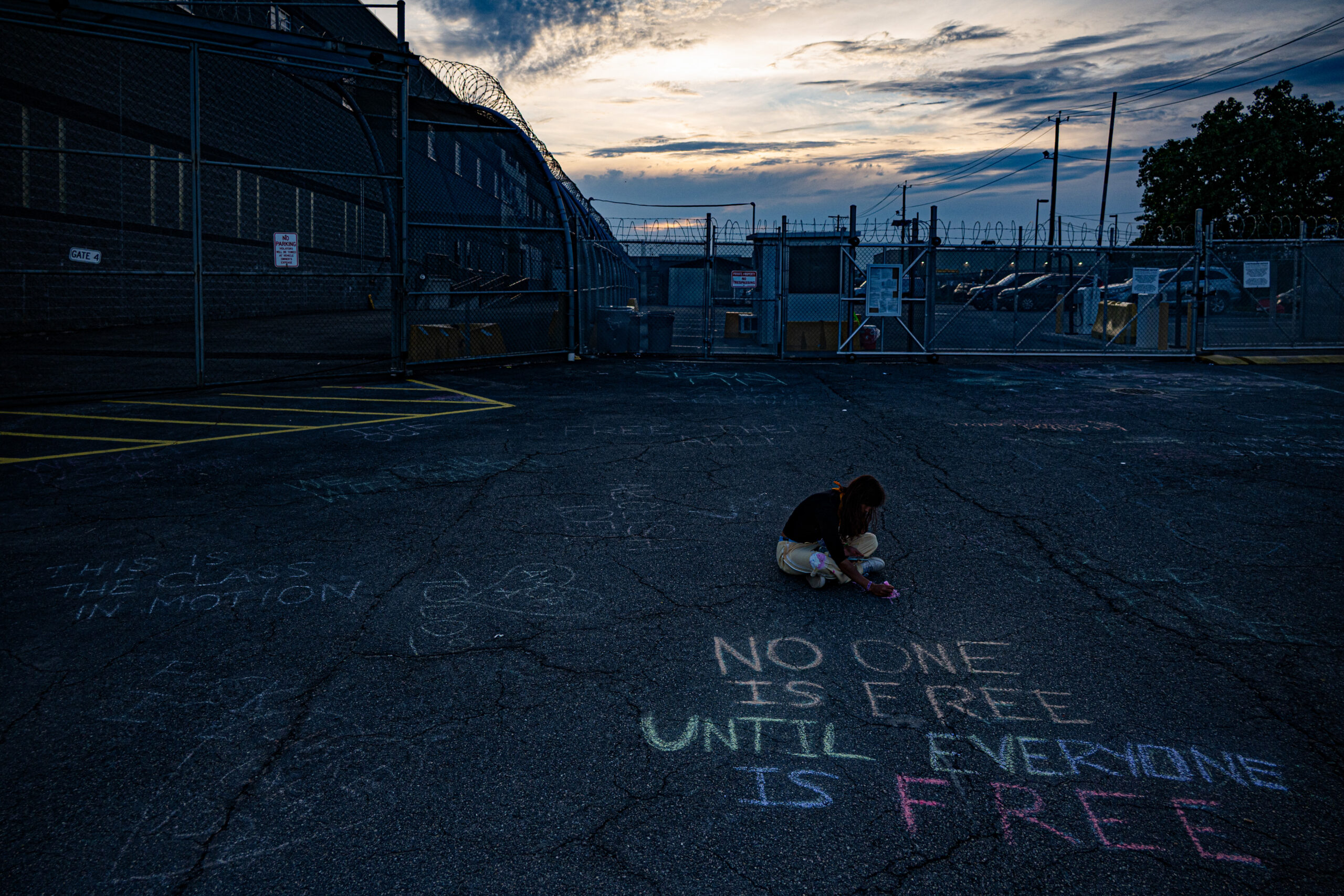 A protester creates chalk art on the driveway outside Delaney Hall detention center in Newark, N.J., on May 27, 2026.