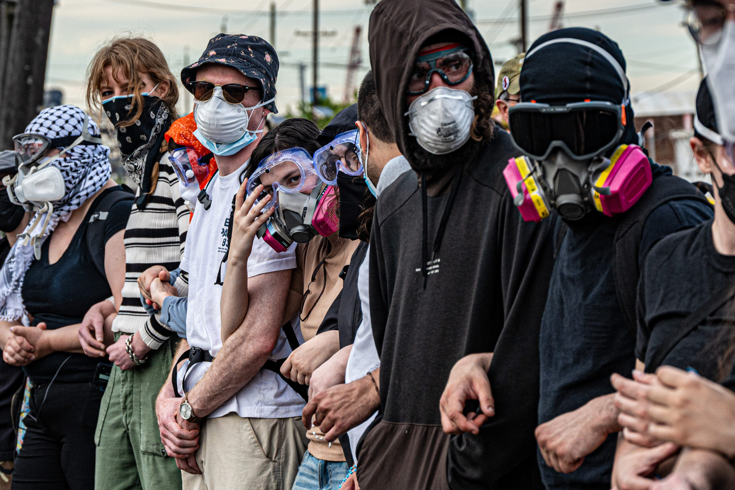 Protesters link arms in an attempt to block federal vehicles from transferring detainees during a hunger strike at Delaney Hall detention center in Newark, N.J., on May 26, 2026.