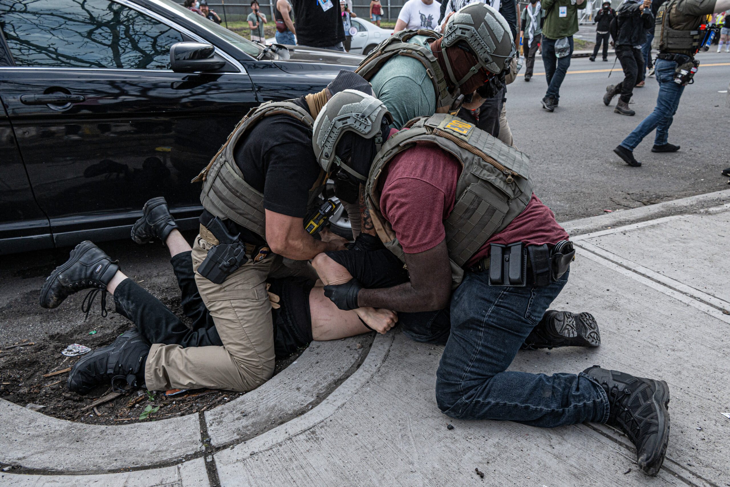 Federal agents detain a protester after an attempt to block a federal vehicle from exiting Delaney Hall detention center in Newark, N.J., on May 26, 2026.