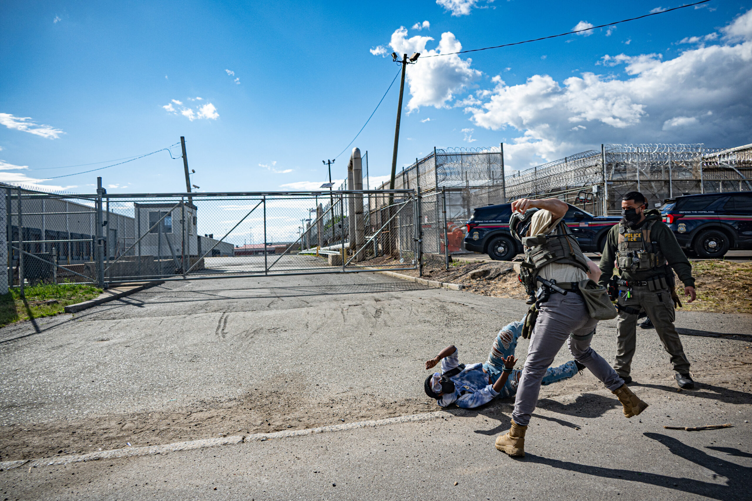 Federal agents force a protester to the ground after the demonstrator attempted to block an ICE vehicle from exiting Delaney Hall detention center in Newark, N.J., on May 28, 2026.
