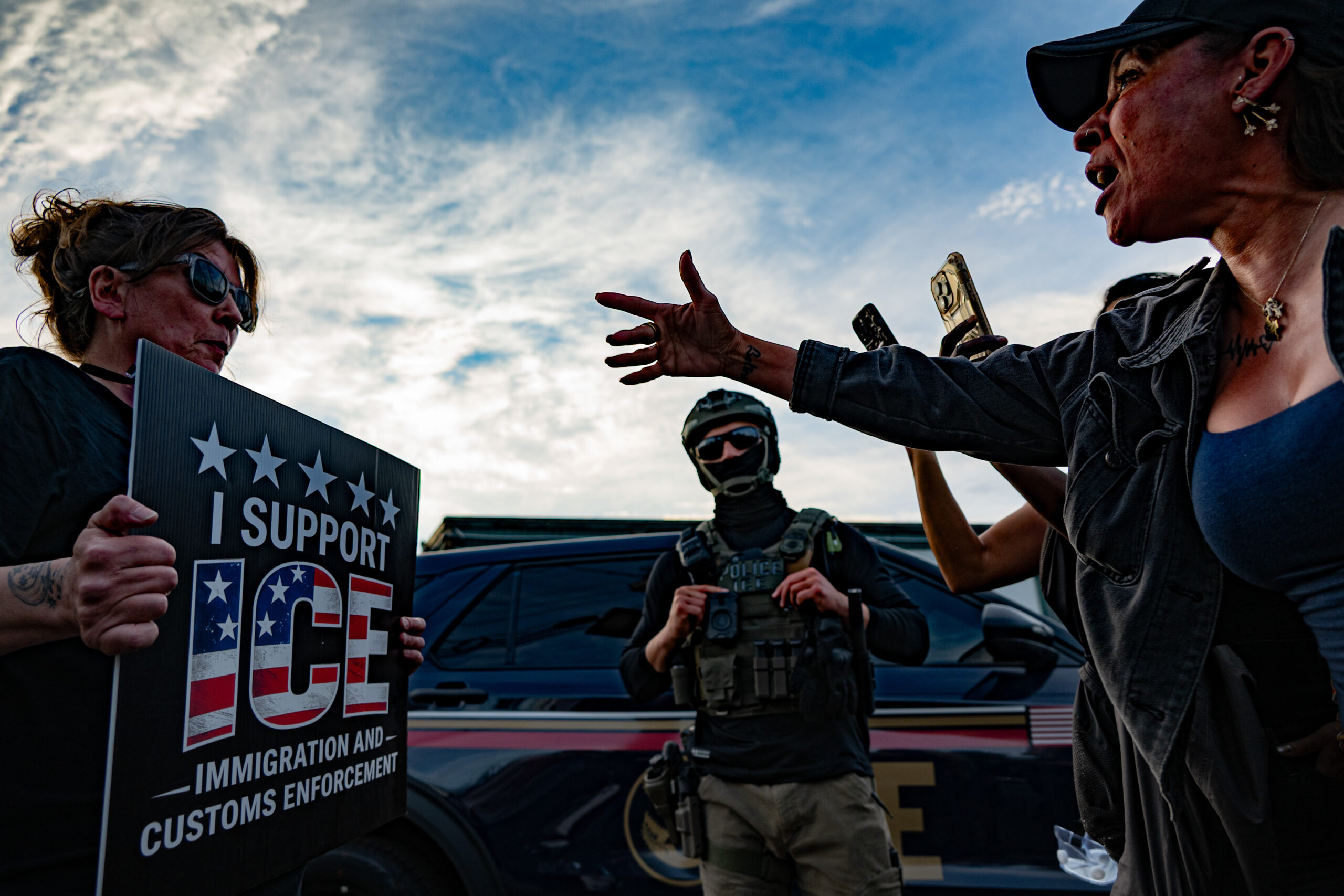 A supporter of ICE confronts anti-ICE protesters as federal agents watch outside Delaney Hall detention center in Newark, N.J., on May 26, 2026. The pro-ICE demonstrator spat on a protester — an act that constitutes simple assault under New Jersey law — but federal agents present did not intervene.