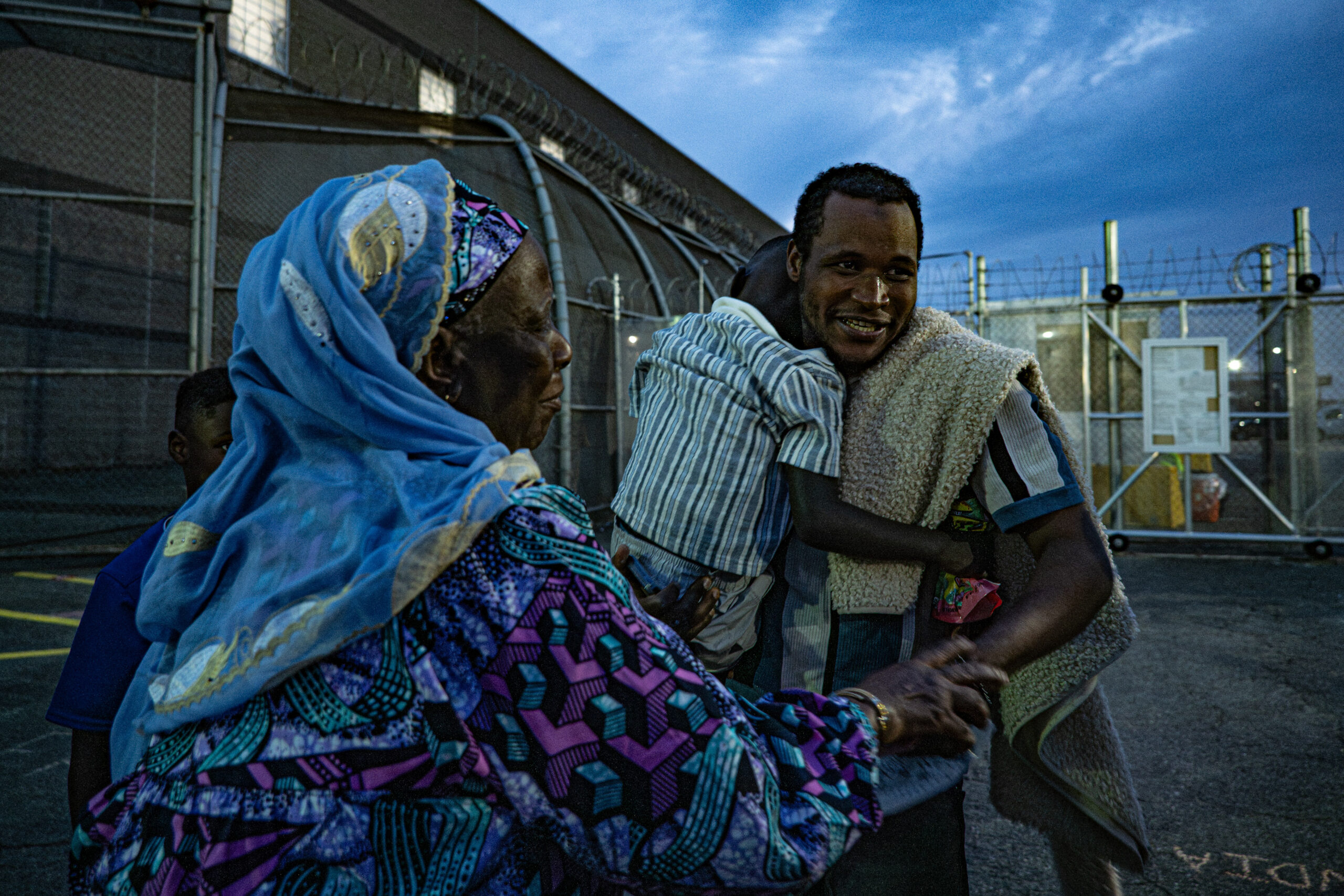 A man is reunited with family after being released from Delaney Hall detention center in Newark, N.J., on May 27, 2026. A protest marshal said the man reported losing 11 pounds and experiencing persistent illness during his detention. The facility was repurposed in 2025 as an immigration processing center after closing in 2023.