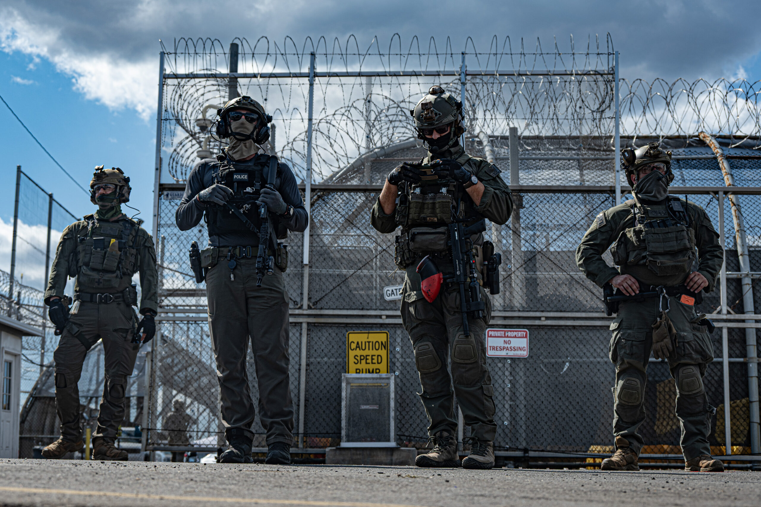 Federal agents armed with rifles loaded with live ammunition and firearms loaded with pepper-ball rounds stand guard outside Delaney Hall detention center in Newark, N.J., on May 29, 2026.