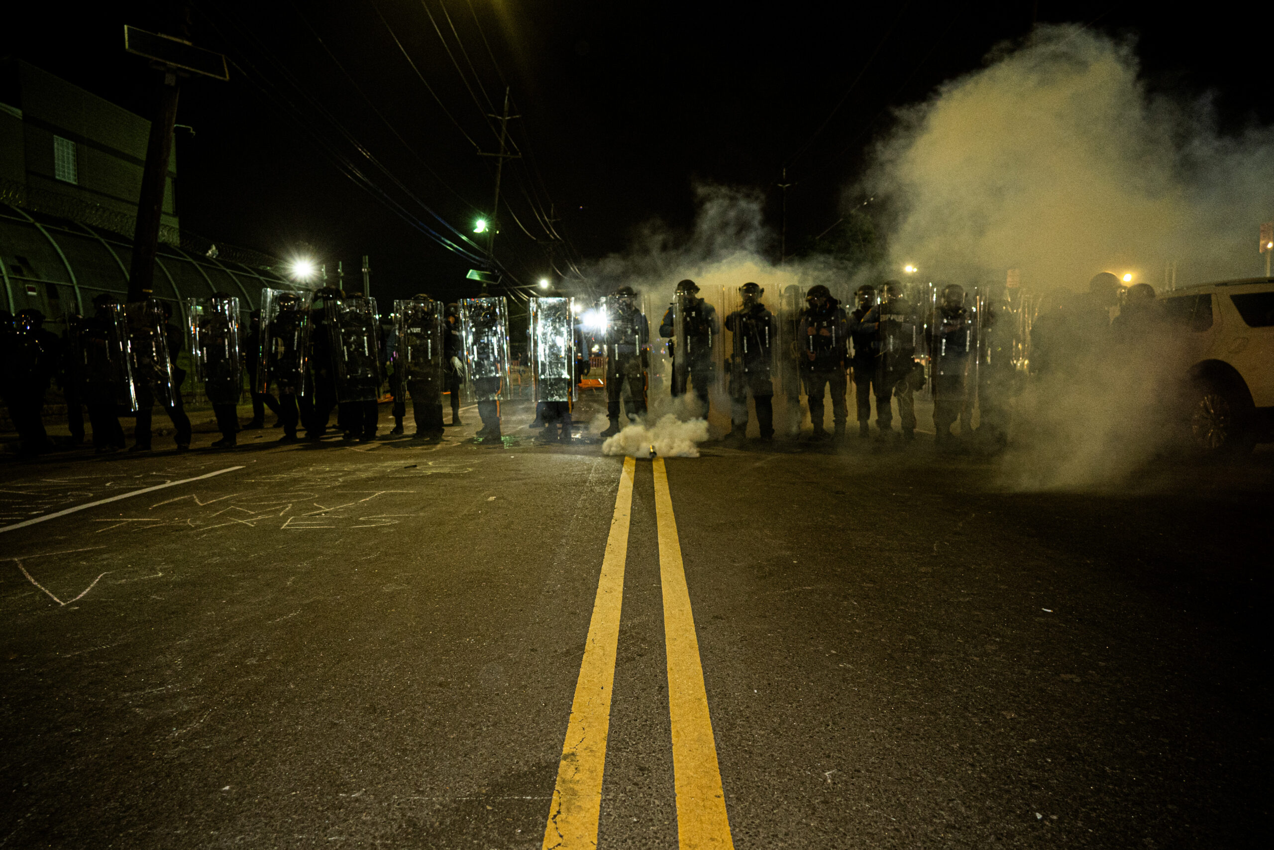 Riot police advance as protesters kick tear gas canisters back toward the police line outside Delaney Hall detention center in Newark, N.J., on May 29, 2026.