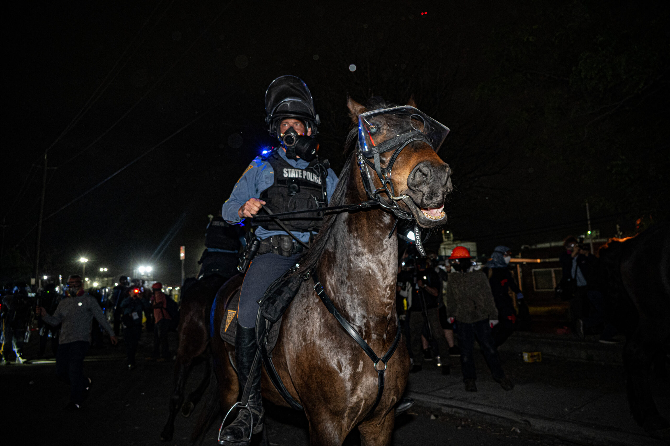 Mounted police push protesters away from Delaney Hall detention center, clearing a path for ICE vehicles to leave the facility without obstruction in Newark, N.J., on May 29, 2026.