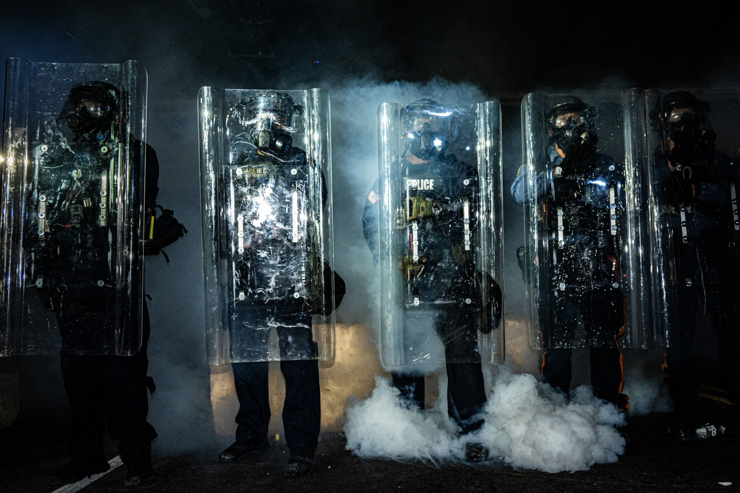 Riot police advance as protesters kick tear gas canisters back toward the police line outside Delaney Hall detention center in Newark, N.J., on May 29, 2026.