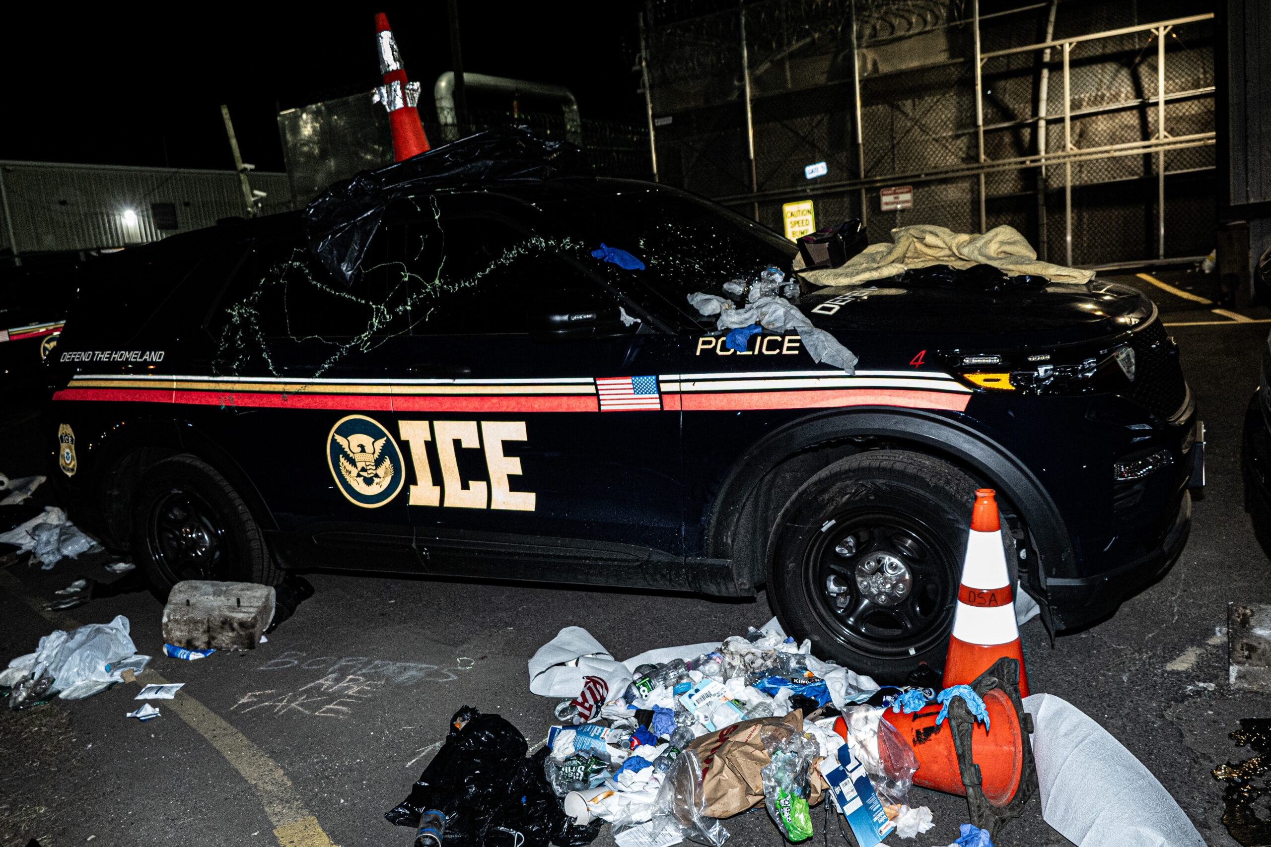 An ICE vehicle is covered in debris during a police riot outside Delaney Hall detention center in Newark, N.J., on May 29, 2026.