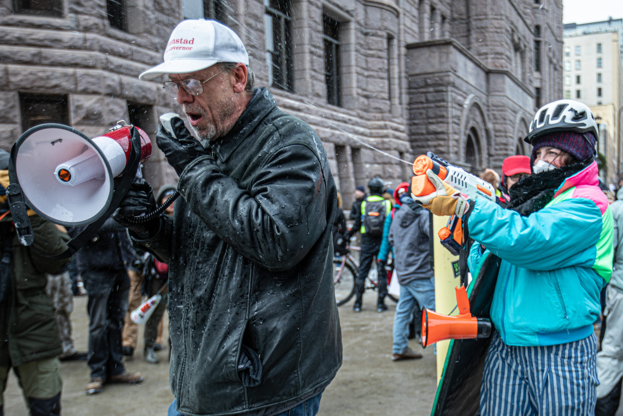 A protester sprays a far-right demonstrator with a water gun during subzero temperatures in Minneapolis on Jan. 17, 2026.