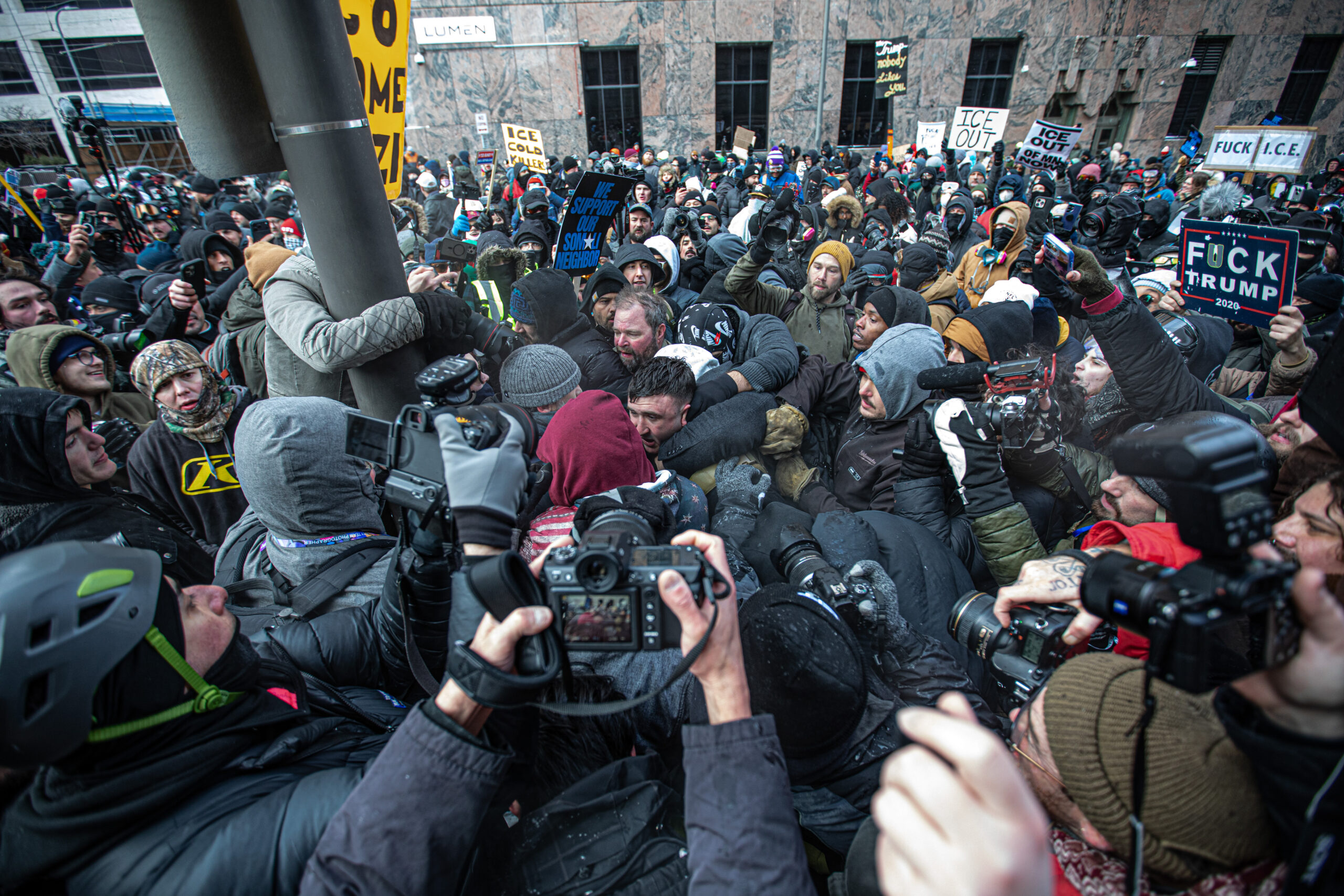 Far-right activist Jake Lang is surrounded by counter-protesters outside Minneapolis City Hall on Jan. 17, 2026. The crowd became unruly after a far-right demonstrator pepper-sprayed counter-protesters.