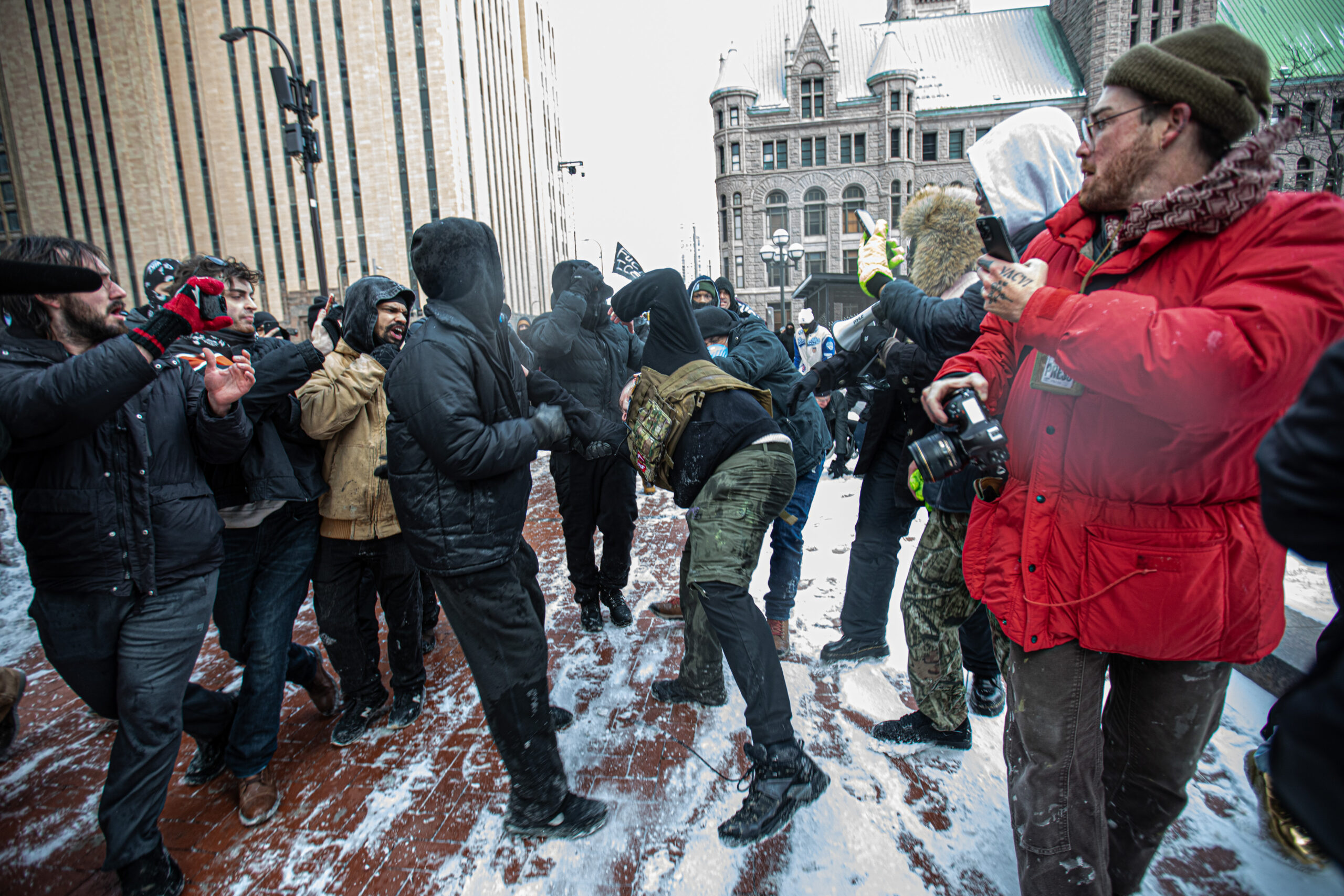 Protesters march through downtown Minneapolis on Jan. 17, 2026, chanting "No hate, no fear, immigrants are welcome here," after Jake Lang left the area. Minneapolis police asked demonstrators to move to the sidewalks.
