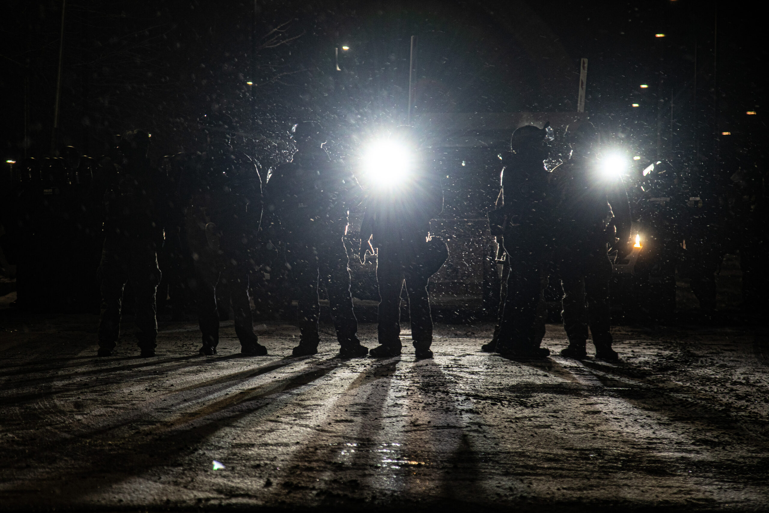 Federal agents from Immigration Customs Enforcement, Enforcement Removal Operations and Homeland Security Investigations stand at the entrance into the Whipple Federal Building in Fort Snelling, Minn., Jan. 16, 2026.